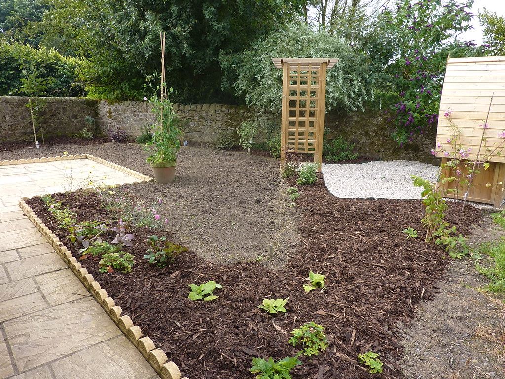 A garden bed dressed with fresh bark mulch