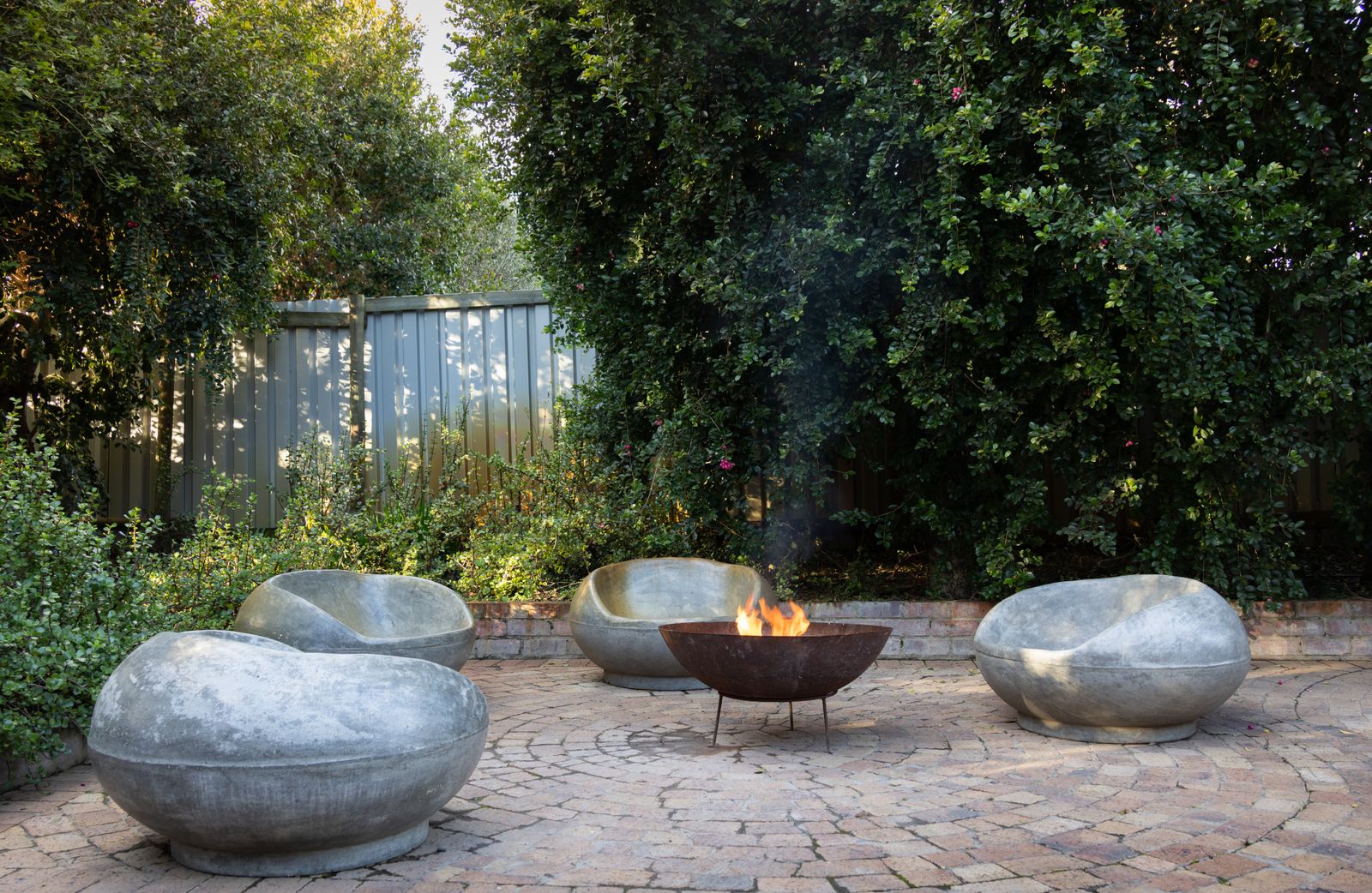 Stone chairs around an outdoor fire pit