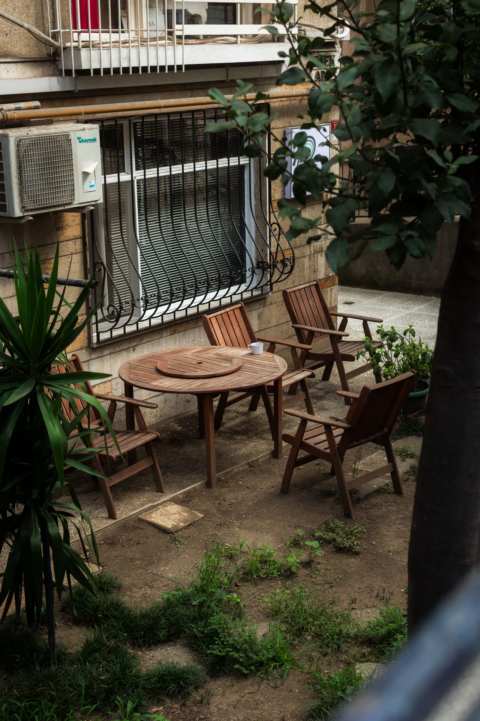 Backyard patio seating surrounded by greenery
