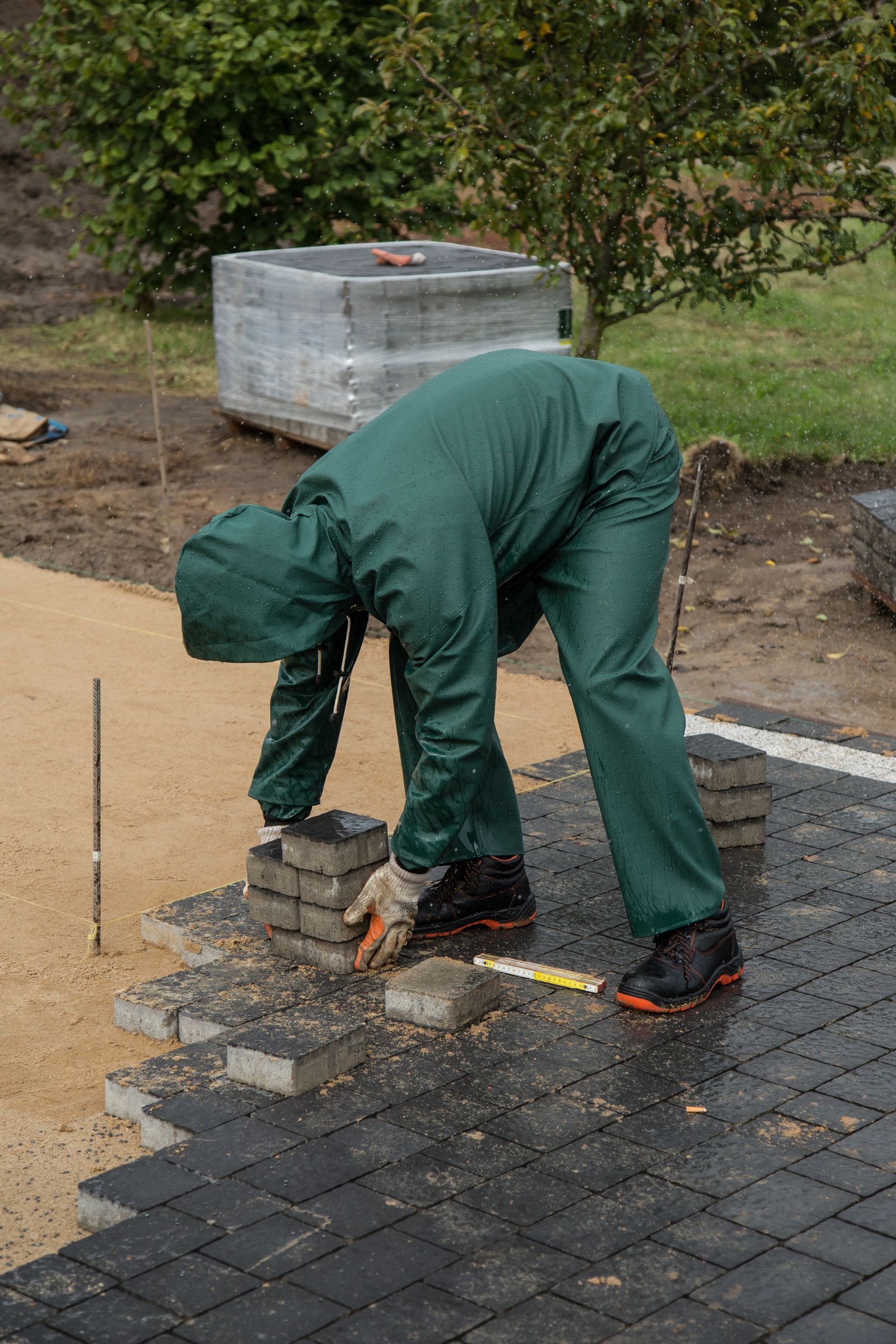 Crew member installing paving stones