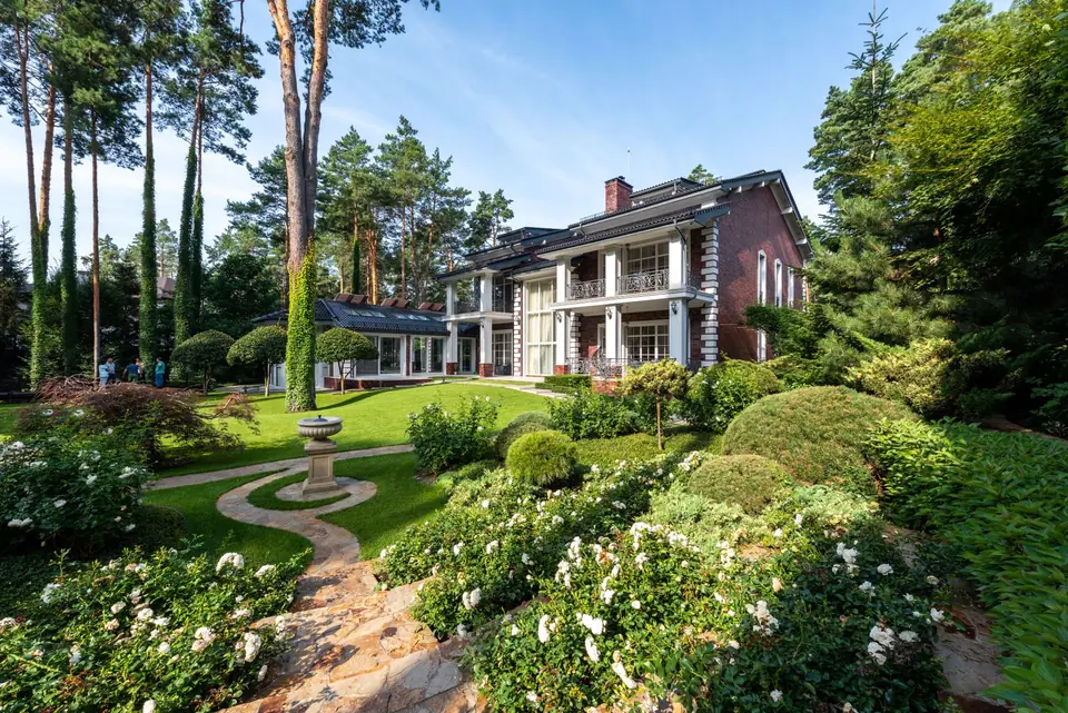 Garden paths curving through planted beds toward a house